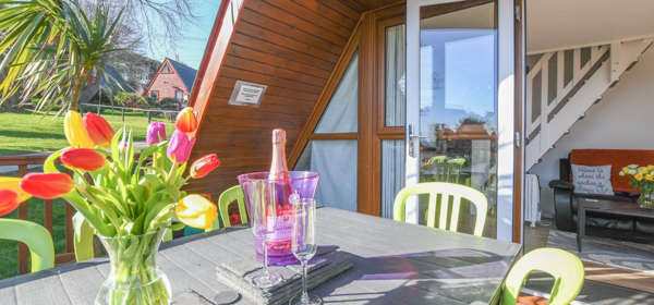 Exterior view with outside seating area, 47 Kingsdown Holiday Park