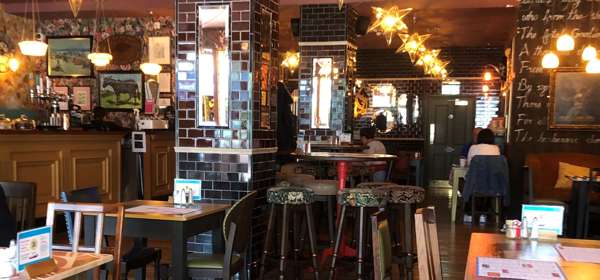 Interior of Acordo Lounge cafe bar with terracotta ceiling, star-shaped lights and wooden floor.