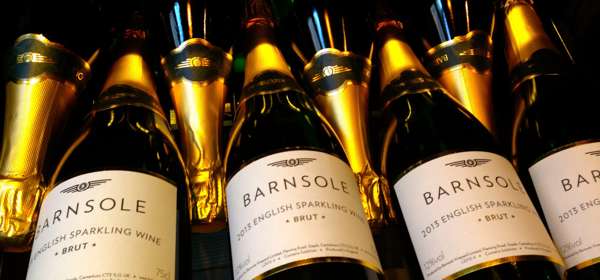 Bottles of Barnsole English sparkling wine lying down with gold tops.