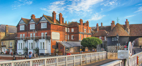 The red-brick Bell Hotel on Sandwich Quay with the metal-framed drawbridge in the foreground.