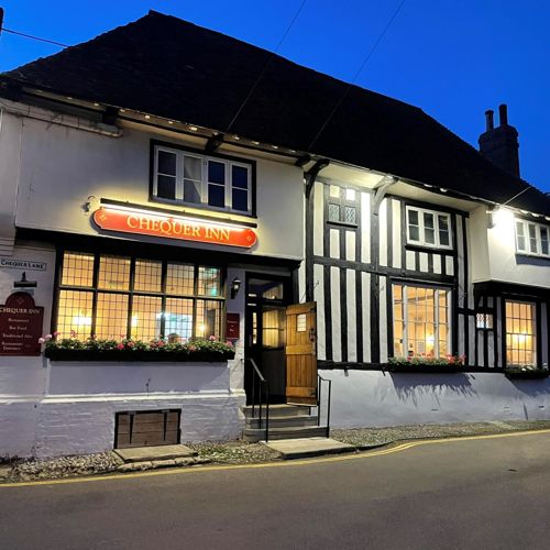 An evening view of the exterior of the Chequer Inn