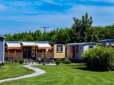 A group of shepherd's huts on a lawn.