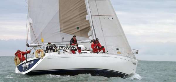 A close up of a yacht and crew out at sea