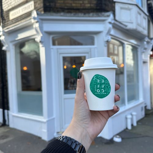 Exterior of Middle Street Coffee Shop featuring an extended are with a coffee cup in the hand