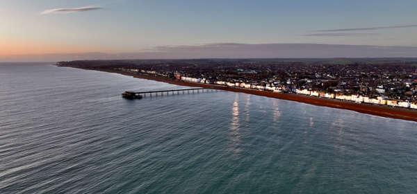 Deal seafront and pier from the air, calm sea, at sunrise