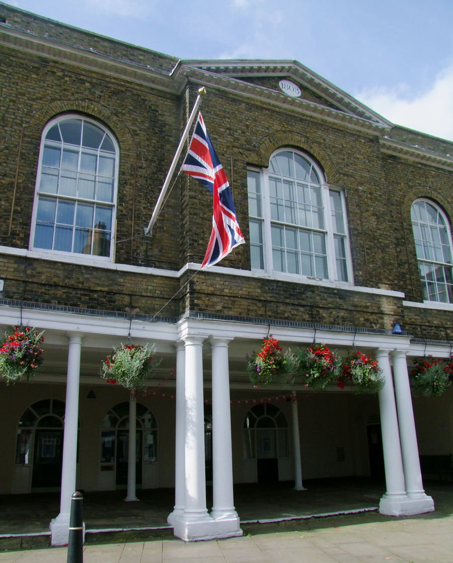 Deal Town Hall with Union Jack flying and colourful hanging baskets. 