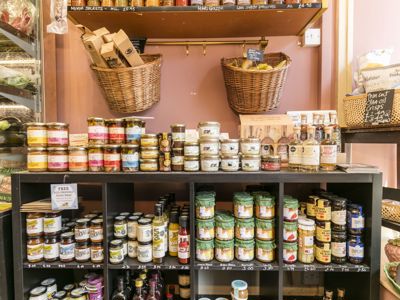 Shelves in a delicatessen loaded with interesting produce.