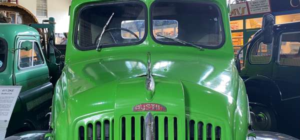 A green vintage truck with sign saying Dover Transport Museum Society