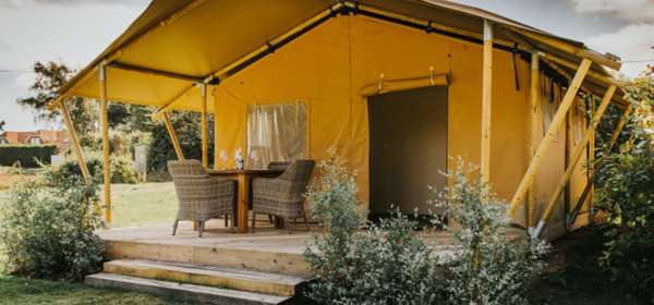 Safari tent with outside deck and table and chairs