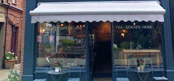 Exterior of the Hope & Lane with bistro tables and chairs.