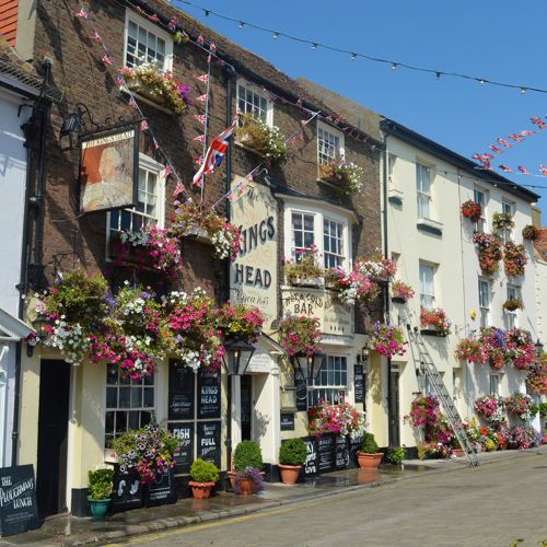 The exterior of the Kings Head with floral hanging baskets