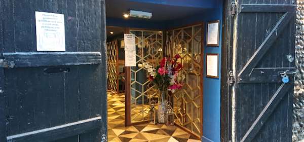 Inviting blue door entrance to Namaste Restaurant