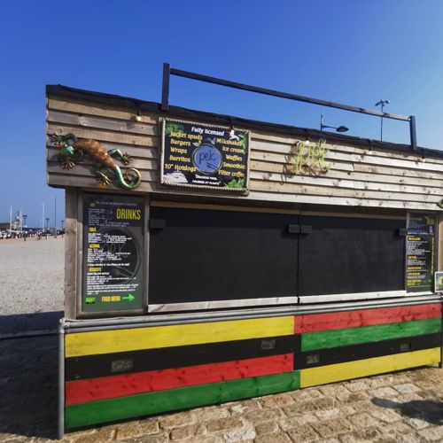 Wooden street food cabin with chalkboard menu.