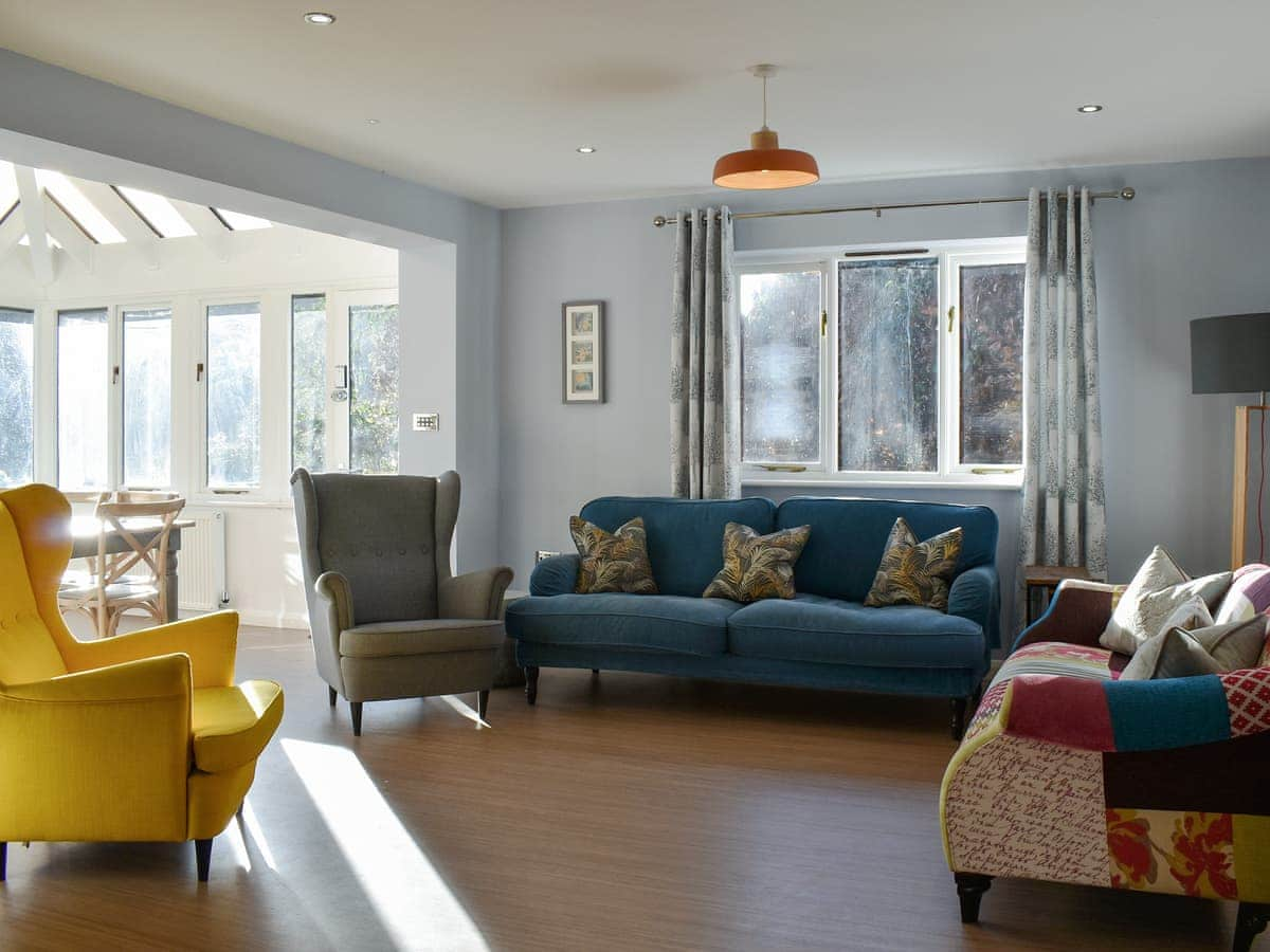 A sitting room next to a conservatory