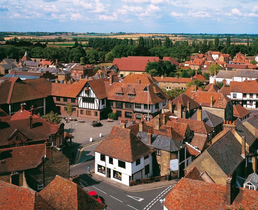 An aerial view of Sandwich town with red tiled rooftops and countryside in the distance