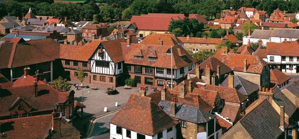 Red tiled rooftops of Sandwich and the black-and-white Guildhall in the centre of the picture