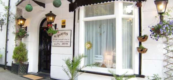 Front door of St Martins Guest House with ferns in pots