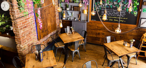 Looking down on the cafe space with wooden tables and chairs.