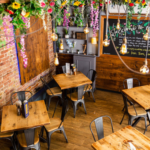 Looking down on the cafe space with wooden tables and chairs.