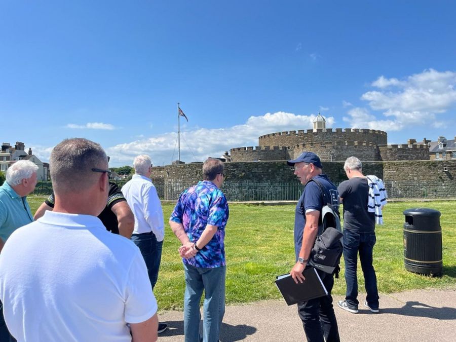 A group of men beside Deal Castle