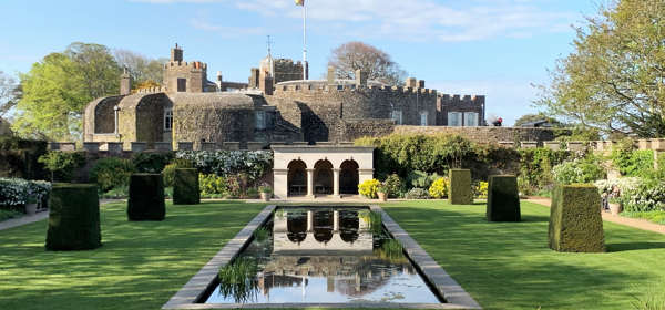 Walmer Castle viewed from the Queen Mother's Garden, with a lake, portico and topiary