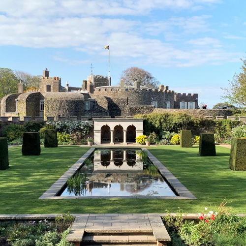 Walmer Castle viewed from the Queen Mother's Garden, with a lake, portico and topiary